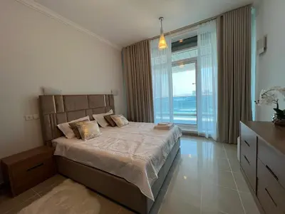 a bedroom with a large bed and a large window at Opal Tower, Marina in Dubai