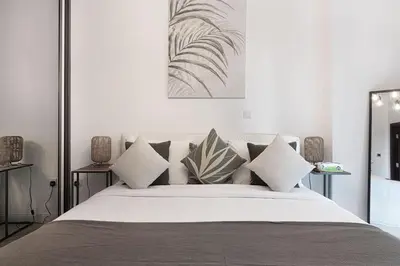 a bedroom with a large bed with pillows on it at Breathtaking Views & Contemporary Comfort in the Heart of Downtown in Dubai