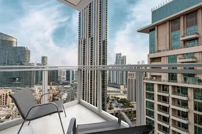 a balcony with a chair and a view of a city at Breathtaking Views & Contemporary Comfort in the Heart of Downtown in Dubai