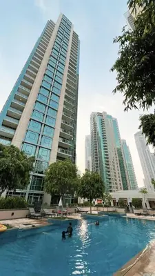 a swimming pool in a city with tall buildings at Breathtaking Views & Contemporary Comfort in the Heart of Downtown in Dubai