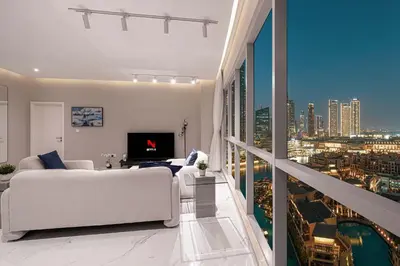 a white living room with a view of a city at Downtown Sanctuary Iconic Burj Views & Luxury Living in Dubai