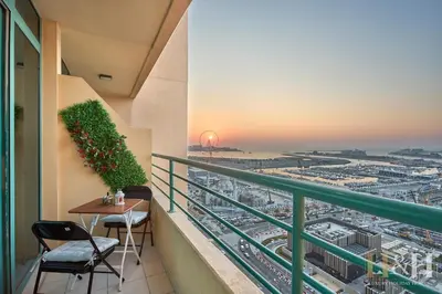 a balcony with a table and a view of a city at Dubai Marina Sea View Sunset View Dubai Eye View in Dubai