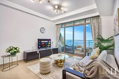 a living room with a couch and a large window at Dubai Marina Sea View Sunset View Dubai Eye View in Dubai