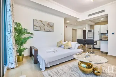 a living room with a bed and a table at Dubai Marina Sea View Sunset View Dubai Eye View in Dubai