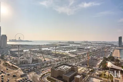 an aerial view of a city with traffic and the ocean at Dubai Marina Sea View Sunset View Dubai Eye View in Dubai
