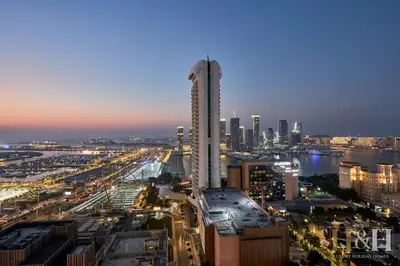 a city skyline with a tall building in the foreground at Dubai Marina Sea View Sunset View Dubai Eye View in Dubai