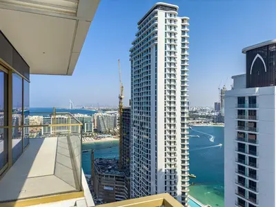 a view from the balcony of a tall white building at Lux Designer 2BR - Grand Bleu - Waterfront Living in Dubai