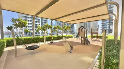 a rendering of a playground with a swing at Lux Designer 2BR - Grand Bleu - Waterfront Living in Dubai