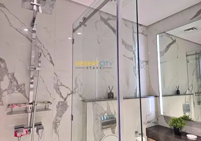 a bathroom with a shower with a glass door at Elegant 2BR in Dubai Hills Estate Hosted by Desert City Stays in Dubai