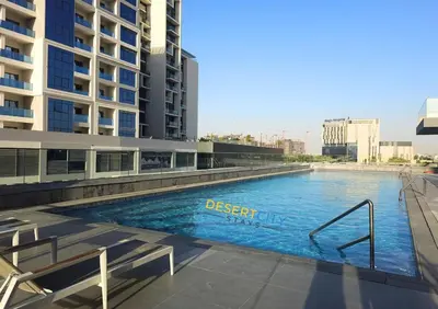 a large swimming pool in the middle of a building at Elegant 2BR in Dubai Hills Estate Hosted by Desert City Stays in Dubai