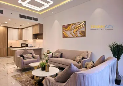 a living room with two couches and a table at Elegant 2BR in Dubai Hills Estate Hosted by Desert City Stays in Dubai