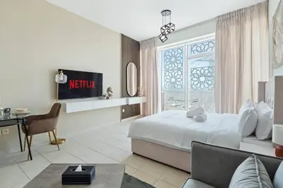a bedroom with a bed and a desk and a couch at 021 - Discovery Gardens (Building 18) in Dubai