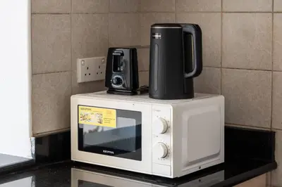 a microwave with a coffee pot on top of it at 021 - Discovery Gardens (Building 18) in Dubai