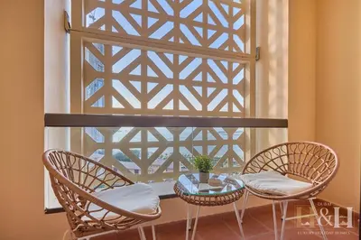 two chairs and a table in front of a window at Stunning views of Dubai Sea, Dubai Eye & JBRWalk in Dubai
