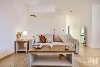 a living room with a couch and a table at Stunning views of Dubai Sea, Dubai Eye & JBRWalk in Dubai