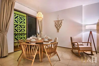 a dining room with a table and chairs at Stunning views of Dubai Sea, Dubai Eye & JBRWalk in Dubai