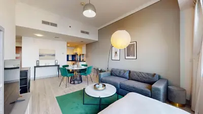 a living room with a couch and a table at Ocean Heights - One Bed with City View of Marina in Dubai