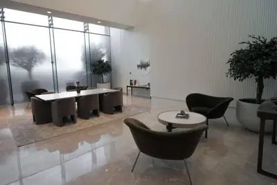 a room with chairs and a table and a room with a table at Forte Tower - Aesthetic Three Bedroom in Downtown in Dubai