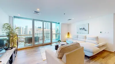 a living room with a couch and a large window at Vacationer I Hidden Gem in Marina l 3 Bedroom I Yacht Views, Free Pool, Gym & Wi-Fi in Dubai
