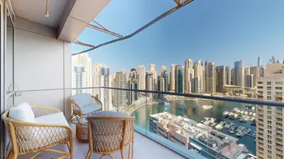 a balcony with chairs and a view of a city at Vacationer I Hidden Gem in Marina l 3 Bedroom I Yacht Views, Free Pool, Gym & Wi-Fi in Dubai