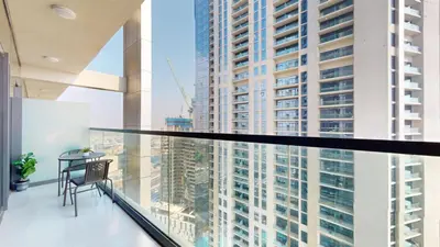 a balcony with a view of a tall building at Aykon Tower - Calm One Bed in Business Bay in Dubai