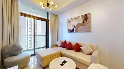 a living room with a couch and a table at Aykon Tower - Calm One Bed in Business Bay in Dubai