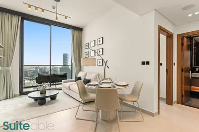 a living room with a couch and a table at Perfect Blend of Comfort and Cozy 1 Bedroom in JVC in Dubai