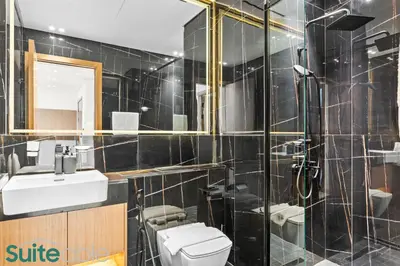 a bathroom with a toilet and a sink and a shower at Perfect Blend of Comfort and Cozy 1 Bedroom in JVC in Dubai