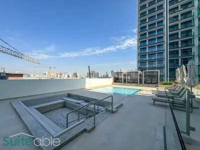 a swimming pool on the roof of a building at Perfect Blend of Comfort and Cozy 1 Bedroom in JVC in Dubai