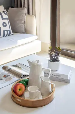 a tray with cups and apples on a table in a living room at Frank Porter - Yansoon 5 in Dubai