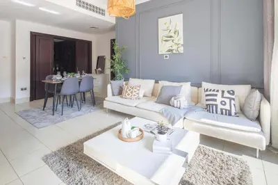 a living room with a couch and a table at Frank Porter - Yansoon 5 in Dubai