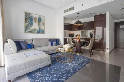a living room with a couch and a table at Frank Porter - Damac Majestine in Dubai
