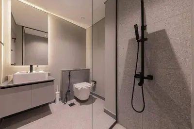 a bathroom with a shower and a toilet and a sink at Brand New Studio 15 mins drive from Business Bay in Dubai