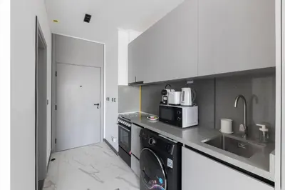 a kitchen with a washing machine and a sink at Brand New Studio 15 mins drive from Business Bay in Dubai