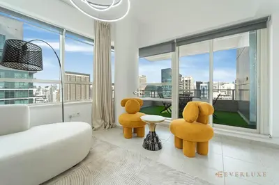 two teddy bears sitting in a living room with a window at Beautiful & Spacious 3 Bedroom Wmaids In Marina in Dubai