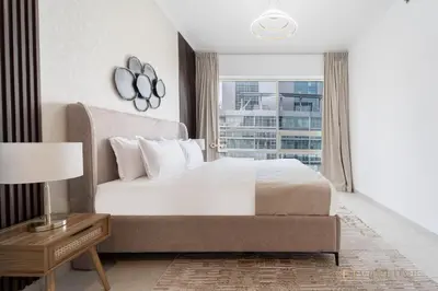 a bedroom with a large bed and a window at Beautiful & Spacious 3 Bedroom Wmaids In Marina in Dubai