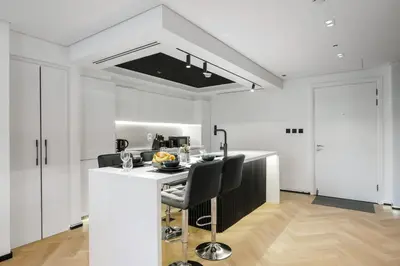 a kitchen with white cabinets and a white counter top at 1 BR Exquisite Urban Living in Downtown Dubai in Dubai