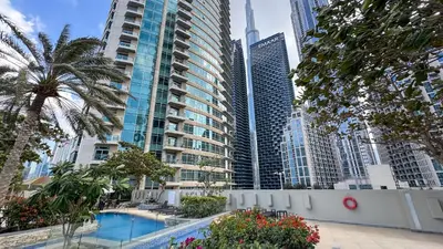 a swimming pool in a city with tall buildings at 1 BR Exquisite Urban Living in Downtown Dubai in Dubai