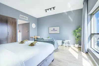 two beds in a room with blue walls at Stylish & Compact Home in the Heart of the JVC in Dubai