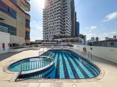a swimming pool on the side of a building at Stylish & Compact Home in the Heart of the JVC in Dubai