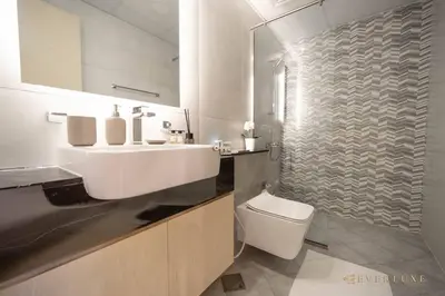 a bathroom with a white sink and a toilet at 1-bedroom Apartment In Binghatti Avenue in Dubai