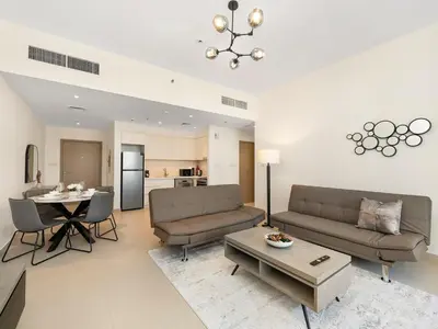 a living room with a couch and a table at Park View Stay at Creek Horizon in Dubai
