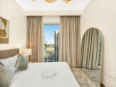 a bedroom with a large bed and a large window at Park View Stay at Creek Horizon in Dubai