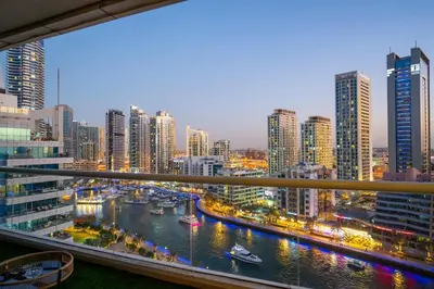 a view of a city with a river and buildings at 13 - Stylish Dorra Bay Family Apartment - Canal View & Pool Access in Dubai