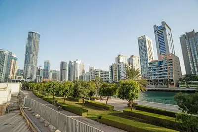 a city skyline with tall buildings and a river at 13 - Stylish Dorra Bay Family Apartment - Canal View & Pool Access in Dubai