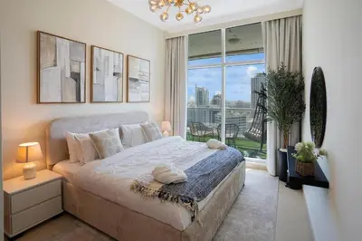 a bedroom with a large bed and a large window at 13 - Stylish Dorra Bay Family Apartment - Canal View & Pool Access in Dubai