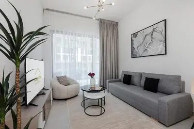 a living room with a couch and a table at Cozy 1BR apartment Binghatti Canal Business Bay in Dubai