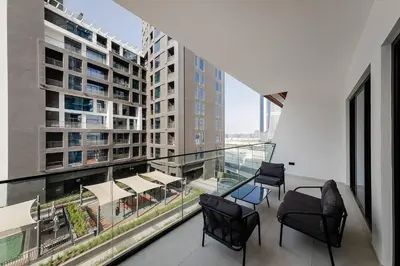 a balcony with chairs and a view of a building at Cozy 1BR apartment Binghatti Canal Business Bay in Dubai