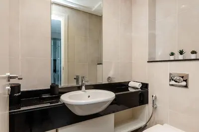 a bathroom with a sink and a mirror at Modern 1BR apartment Artesia DAMAC Hills in Dubai