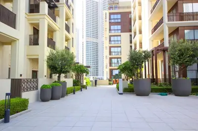 a walkway with potted trees and buildings at Breeze haven residences- 2BHK brand new furnished apartment in Dubai